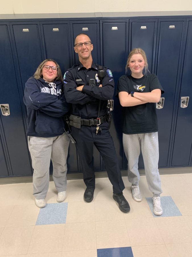 Officer Krause poses with interviewers (from left) Stella Heinze and Emma Duvall after their interview Friday, November 11.