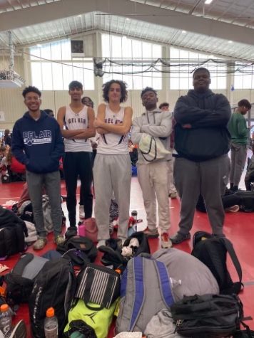 A few members of the indoor track team pose triumphantly.