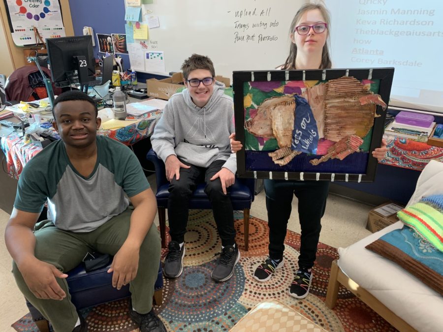 Jona Wills, Jeffrey Coker (center) and Corrine Emerson pose with their completed cardboard relief in Ms. Nicole Jergensens classroom.