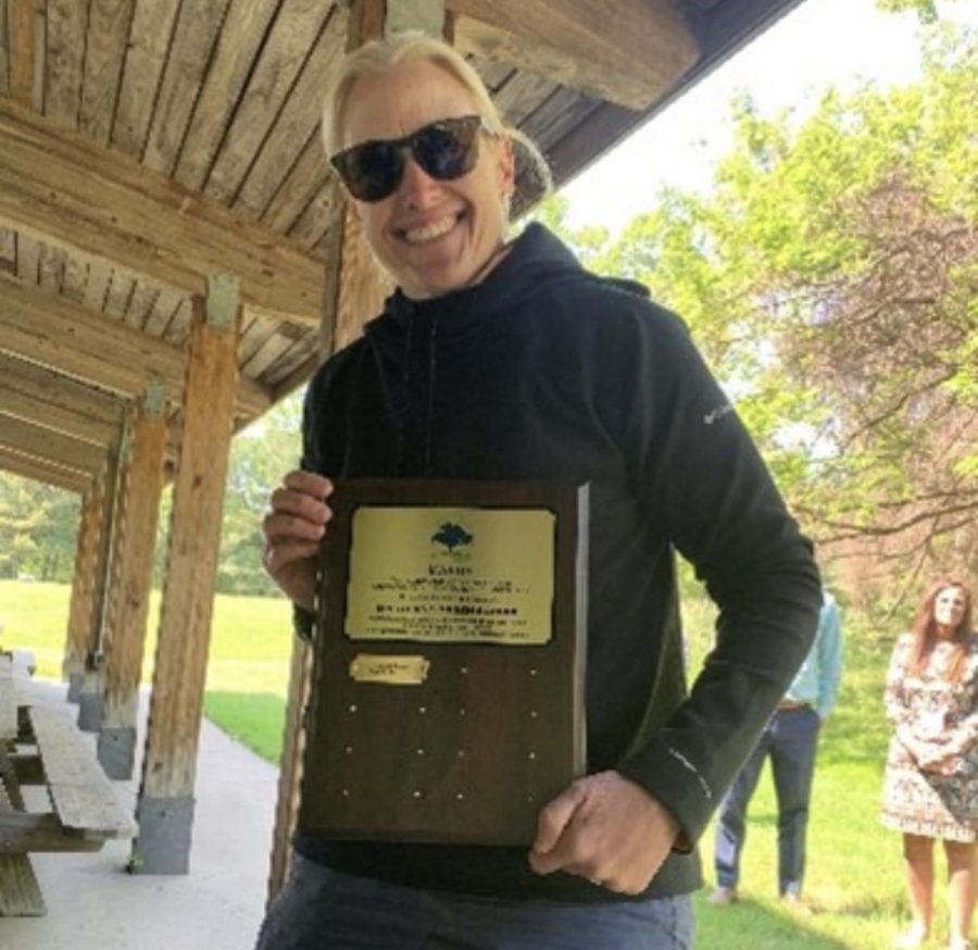 Snell poses with BAHSs award.