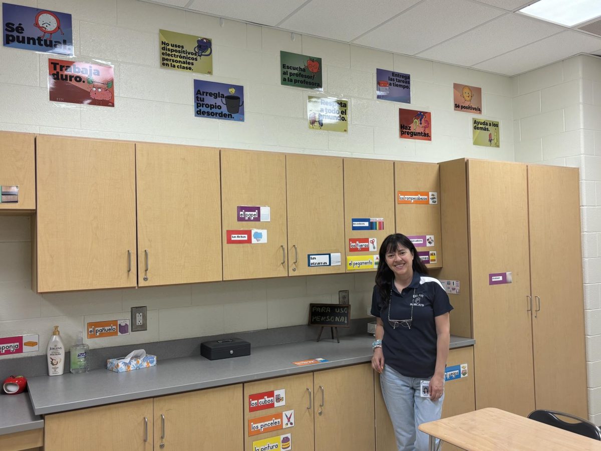 Ms. Delgado poses in her newly decorated classroom on Friday.