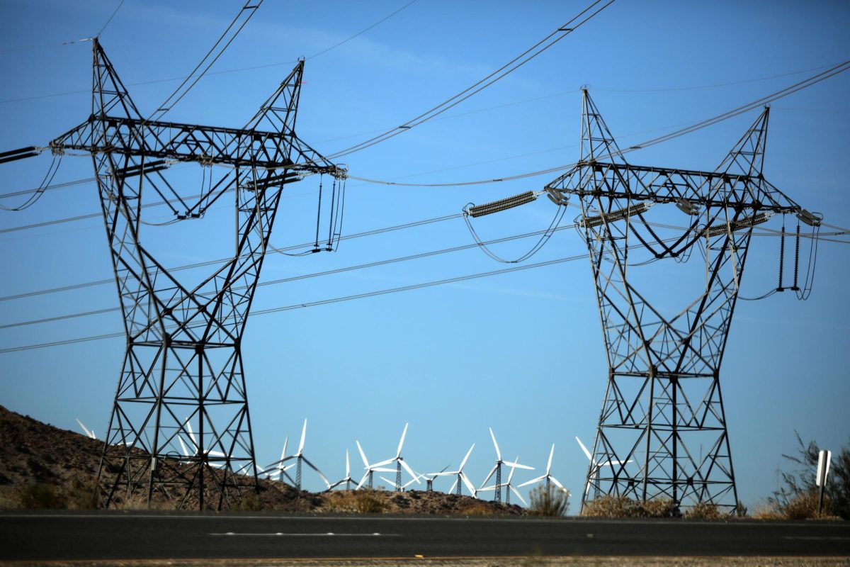 Windmills are seen behind electricity pylons in Palm Springs, California, U.S., November 25, 2017. REUTERS/Lucy Nicholson