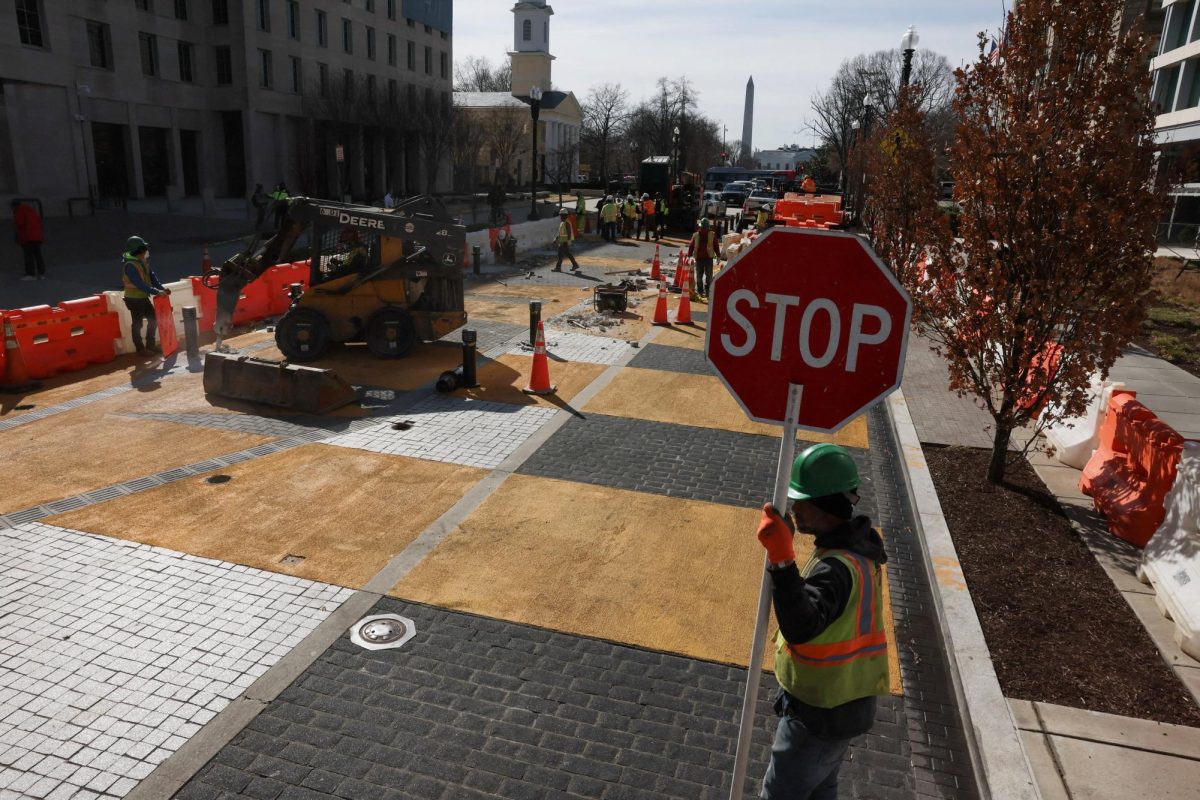 People work to transform Washington, D.C.'s Black Lives Matter Plaza, as part of a new mural project, after threats by Congressional Republicans to cut transportation funding if the plaza was not renamed, in Washington, DC, U.S., March 10, 2025. REUTERS/Leah Millis