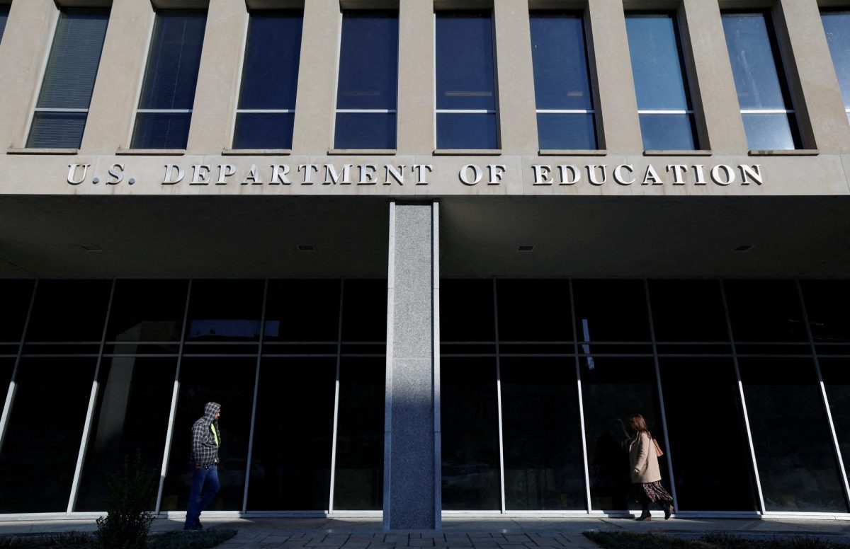 People walk in front of the Department of Education building, amid reports that U.S. President Donald Trump's administration will take steps to defund the federal Education Department, in Washington, U.S., February 4, 2025. REUTERS/Kevin Lamarque