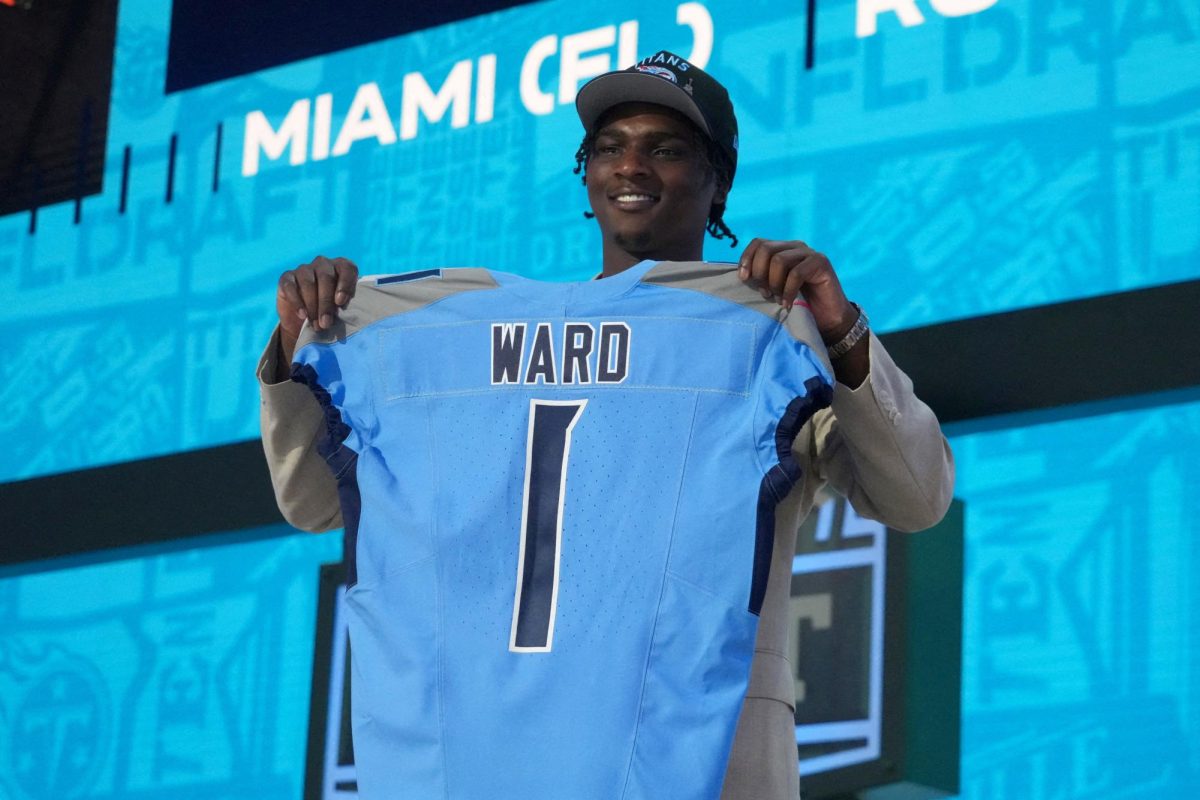 Apr 24, 2025; Green Bay, WI, USA; Miami Hurricanes quarterback Cameron Ward holds the jersey on stage after he is selected by the Tennessee Titans as the number one pick in the first round of the 2025 NFL Draft at Lambeau Field. Mandatory Credit: Kirby Lee-Imagn Images