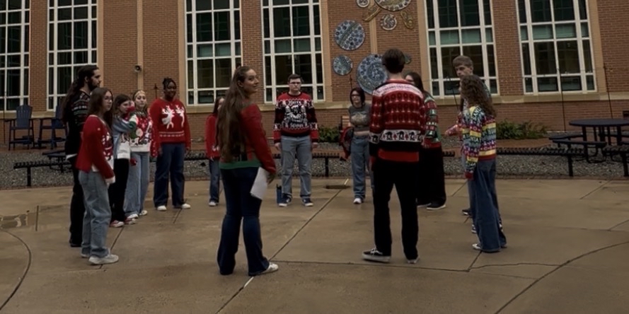 The pop choir rehearses quickly before Friday's performances in the Bel Air High School courtyard.